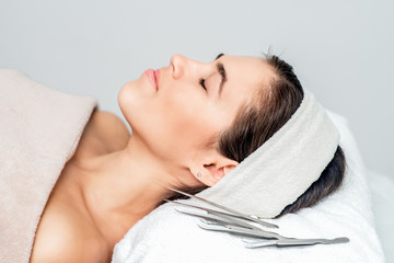 Fototapeta na wymiar Beautiful woman with closed eyes lying ready for skin care and procedures.