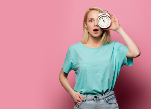 Beautiful Blonde Woman With Alarm Clock On Pink Background