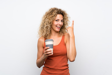 Young blonde woman with curly hair holding a take away coffee intending to realizes the solution while lifting a finger up