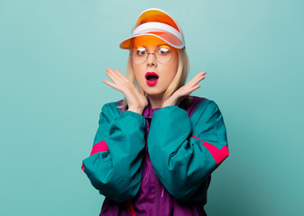 Style blonde woman in 80s glasses and hat