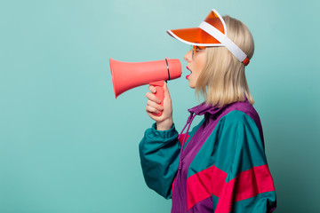 Style blonde woman in glasses with loudspeaker