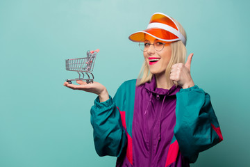Style blonde woman in 90s sport suit with shopping cart