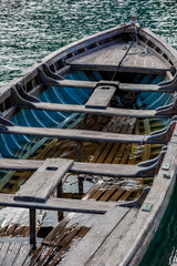 Closeup of retro wooden white boat anchored in harbor
