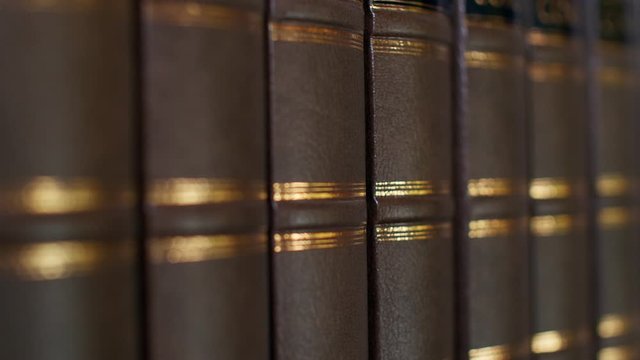 Books on the table in library, shallow depth of field. Books with a luxurious leather binding. 4k