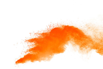 Abstract orange powder explosion. Closeup of orange dust particle splash isolated on white...