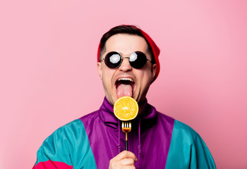 Style guy in glasses with orange on a fork