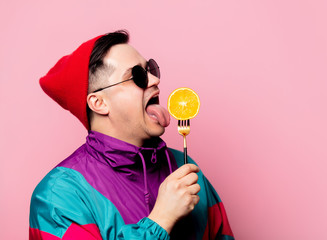 Style guy in glasses with orange on a fork