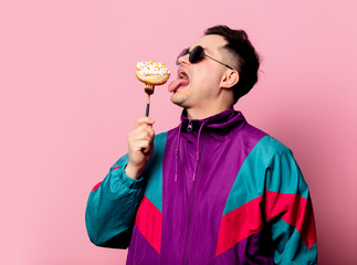 Style guy with donut on fork on pink background