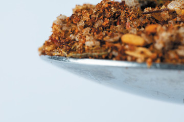 chilli spices on a kitchen spoon close-up