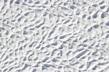 White texture of Pamukkale calcium travertine in Turkey, uneven pattern of cells close-up