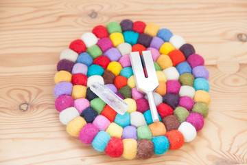 healing tuning fork and crystal stone on table .
