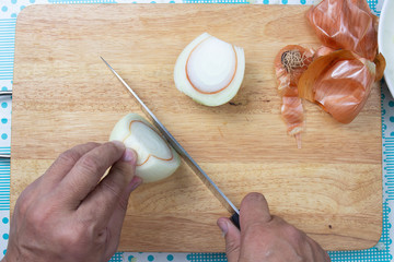 Chef cuttng onion before cooking
