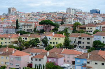 Fototapeta na wymiar Lisbon, Portugal city skyline over the Alfama district. Summertime sunshine day cityscape in the historic old district. Lisbon red rooftops
