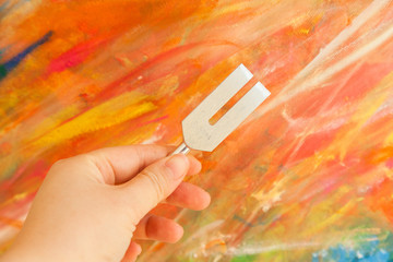 Hand holding a tuning fork .