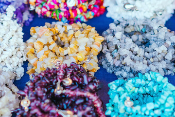 The colorful stone is used to make beautiful bracelets. Is a religious belief of Thai people that will have good luck for sale on the local market in Kanchanaburi, Thailand. Selective focus.