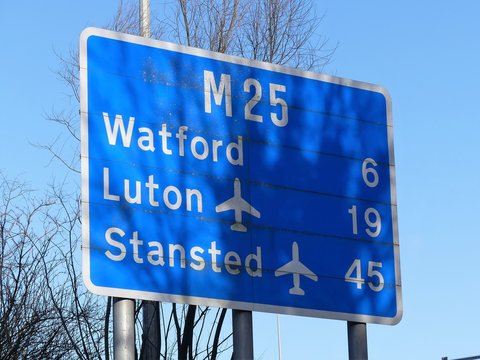 M25 motorway sign at Chorleywood, Hertfordshire showing distances to Watford, Luton Airport and Stanstead Airport
