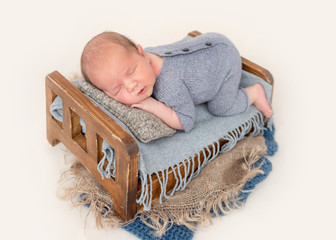 Newborn sleeping on tiny bed