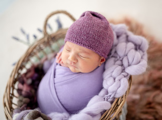 Cute newborn in purple hat