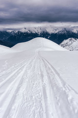 Winter in the mountains and the snowy valleys of the Alps during a fantastic winter day, near the town of Schilpario, Italy - January 2020.