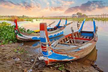Colorful traditional boats on the side of the Taung Tha Man Lake, near the the U Bein Bridge,...