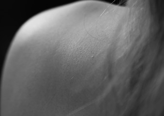 Human skin chills on shoulder hair woman background