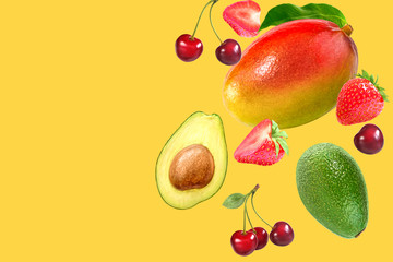 Summer fruits concept background with layout made with mango, cherry, strawberry and avocado. Copy space.