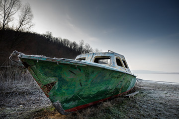 old fishing boat on the beach of the river