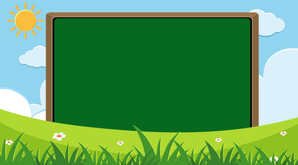 Blank chalkboard with green grass background © brgfx
