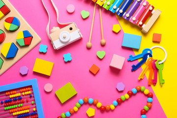 Colorful kids toys on pink background. Top view, flat lay.