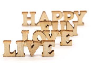 wood letters arranged on white as motivational messages live love fun happy words abstract photo