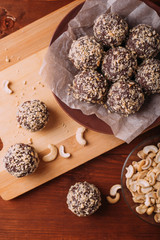 Cocoa balls, chocolate truffles cakes on board on wooden background