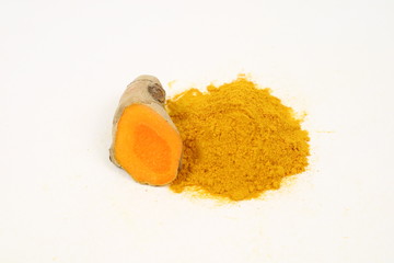Turmeric powder and turmeric root extract on a white background, used as a tonic for body and food ingredients.