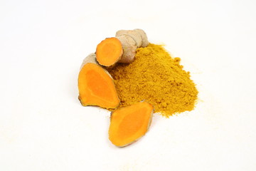 Turmeric powder and turmeric root extract on a white background, used as a tonic for body and food ingredients.