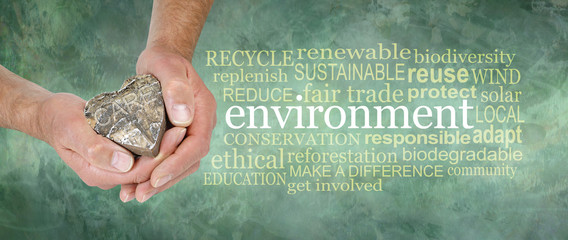 Love and care for the environment Word Cloud - male hands holding a wooden heart beside an...