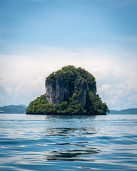 Thai Karst Water Rock Formations reflecting in the waters of Phang Nga Bay, east of Krabi Thailand. Beautiful sheer stone faces, Karst is a topography formed by dissolution of limestone, quartz, etc 