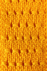 Close-up abstract yellow knitted background.