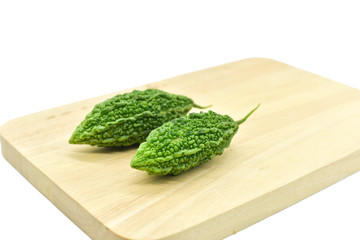 Bitter Melon or Bitter Gourd on Wooden Cutting Board