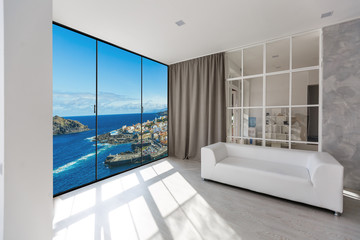 White couch against huge window with panoramic view