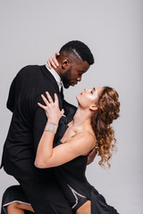 Couple dancers posing over white background. Dance school concept