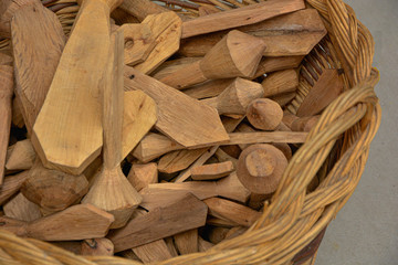 Different clappers of wood in wicker basket.  Factory