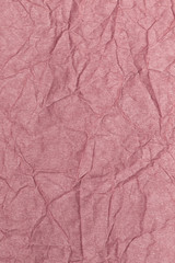Closeup flatlay vertical photography of pastel pink crumpled paper. Abstract photo background.