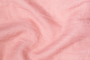 Fototapeta premium Closeup flatlay horizontal photography of pastel pink smooth wavy soft texture of cotton fabric. Abstract photo background.