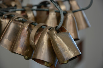 golden cowbells hung on wire in factory