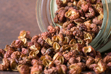 Szechuan Peppercorns Spilled from a Spice Jar