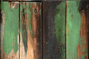 Aged wooden planks with some green paint. Old wood texture background.