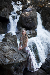Girl on the background of a waterfall