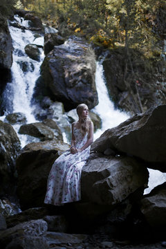 Girl on the background of a waterfall