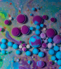 Ink Bubbles In Water. Colorful ink reacting in water creating abstract background.