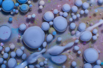 Ink Bubbles In Water. Colorful ink reacting in water creating abstract background.