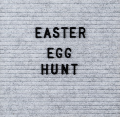 The words Easter Egg Hunt on grey felt letter board